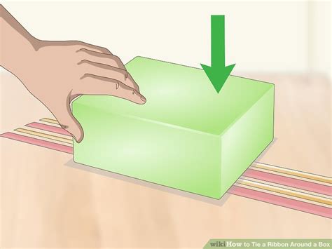 Ribbon ties match the colour of the box with one length fixed to the body of the box and one to the front closure flap. 3 Ways to Tie a Ribbon Around a Box - wikiHow