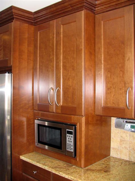 Donna dufresne design these corner diagonal cabinets maximize storage space with open cubbies for a microwave, small tv and cookbooks. Built in Microwave cabinet to countertop. This is a great ...