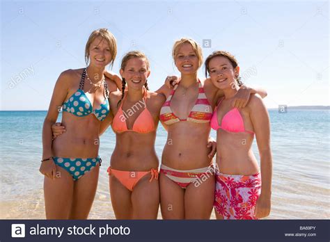 Investing in pants may be the perfect investment. Teenage girls posing at beach Stock Photo: 23496339 - Alamy