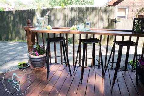 Perfect way to keep your deck clean of clutter with extra chairs bench railing serves a duel purpose to add railing and seats all in one. Build a DIY Flip Up Deck Bar! ~- Designed Decor
