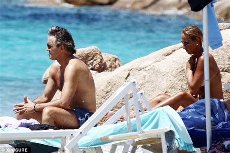 Roberto mancini and his wife turned heads as they soaked up the sunshine in saint tropez. Roberto Mancini shows off his toned body as he protects his skin with sunblock | Daily Mail Online