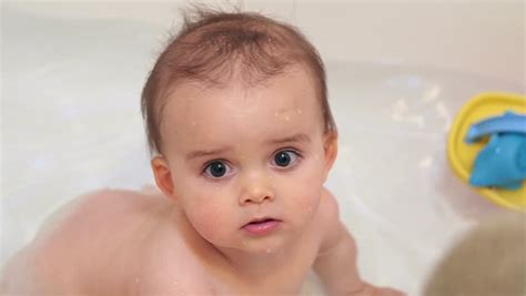 Just don't overdo it on the bubble bath or your baby may get overwhelmed. Newborn Baby Boy Having Bath By His Mother In Bath Tub ...