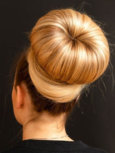 A bun is a type of hairstyle in which the hair is pulled back from the face, twisted or plaited, and wrapped in a circular coil around itself, typically on top or back of the head or just above the neck. VIDEO - Red sofa, blonde hair - RealRapunzels