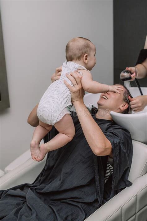 Turn down water temperature when shampooing. Mother With Baby In Beauty Salon Waiting For Master ...