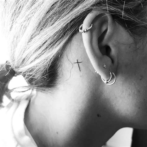 A tattoo that is placed behind the ears is called a cross tattoo and is often referred to as a celtic cross tattoo. Holy cross behind the ear #minimaltattoo #tattoo # ...