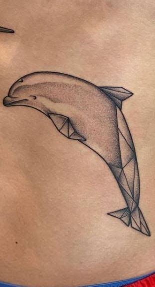 Amazing dolphin tattoos on lower back. Dolphin Tattoos - Ideas, Meanings & Designs - Tattoo Me Now