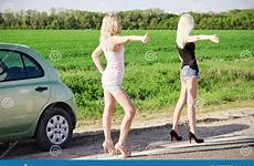hitchhiking girls blonde car broken two sexy standing near their road stock