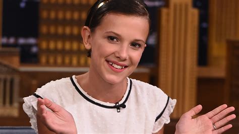 Brown wears a balenciaga dress and tights; Millie Bobby Brown Fakes