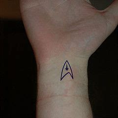 This tattoo is colored with bright yellow ink, and it not every star trek tattoo has to have a picture because this one is just the three famous words of the. Combadge tattoo (With images) | Star trek tattoo, Fandom ...