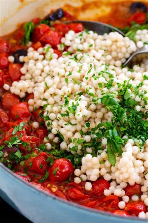 Serve the finished couscous topped with the cooked vegetables and sauce and seasoned eggs. Israeli Couscous with Tomato and Olives - Jessica Gavin