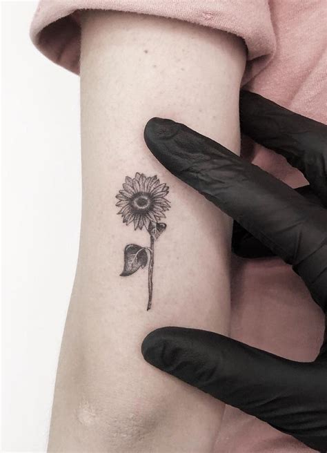 Multiple small hand tattoos can be created to complement each other in some way. minimalist sunflower tattoo © tattoo artist Vinícius ...