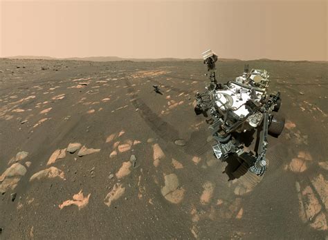 A second round of cheers and applause partially obscured by a dust cover, the first picture was a view from one of the perseverance's hazard cameras. Epic Mars Selfie: NASA's Perseverance Rover With the Ingenuity Helicopter