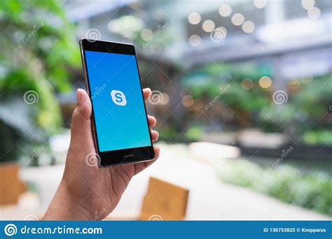 Get skype for windows 10. CHIANG MAI, THAILAND - May 05,2018: Man Holding HUAWEI ...