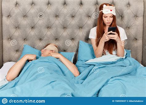 So don't worry girls i know how you can impress your dear boyfriend and just i told you first you need to find the. Beautiful Ginger Girl Reading Her Husband`s Chat While He Is Sleeping On The Bed Stock Image ...