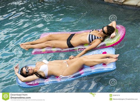 Niños jugando en el agua. Female Friends In The Pool On A Float Royalty Free Stock ...