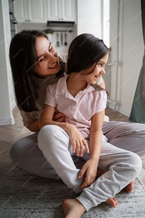 Premium Photo | Mother tickling girl front view