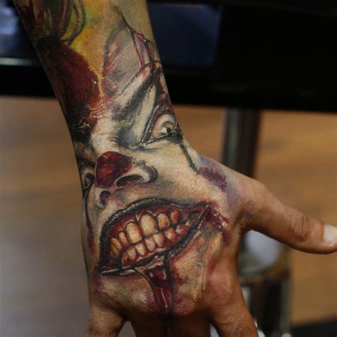 Spelling a word or phrase across four (or eight if you choose to tattoo both hands) may suit your personality. Scary Clown Hand Piece | Best tattoo design ideas