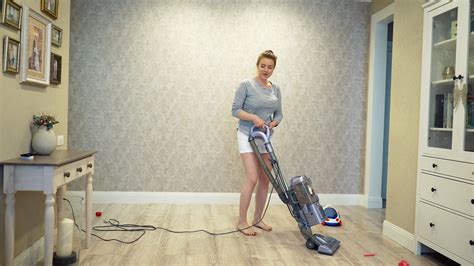 Understanding how vacuum cleaners work is important. Woman cleaning using vacuum cleaner, effective. Vacuum ...