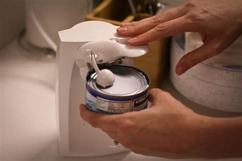 Then, squeeze the arms firmly. How to Use a Can Opener | Hunker