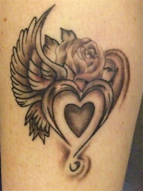 Above it is the name finch, her boyfriend. My Heart rose wing tattoo | Shape tattoo, Rose heart ...