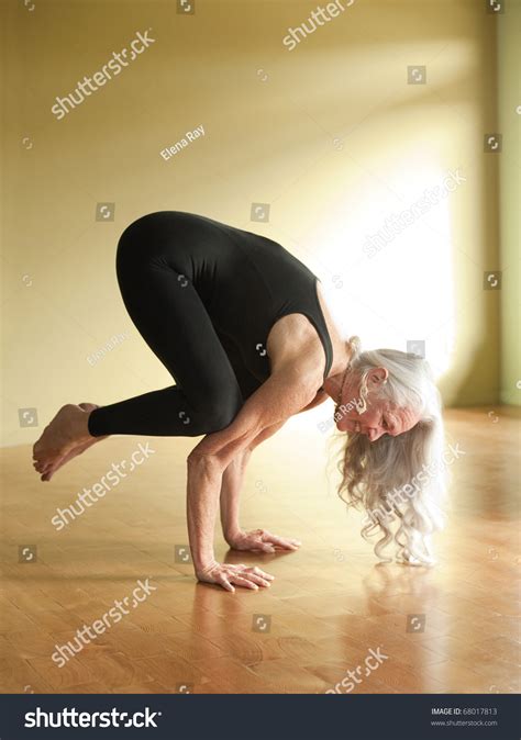 Are you ready to soar? Mature Woman Yoga Posture Bakasana Crow Stock Photo ...