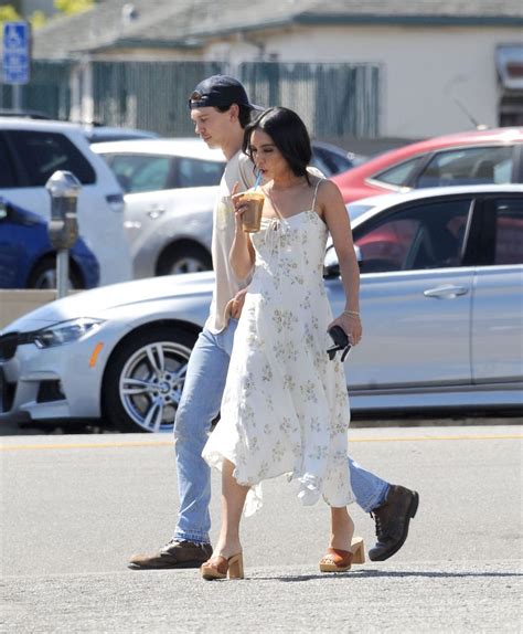 Vanessa wears a black dress with a sheer top half. VANESSA HUDGENS and Austin Butler at Blue Bottle Coffee in ...