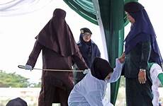 whipped sharia sipa whipping aceh indonesia pleaded masked officer