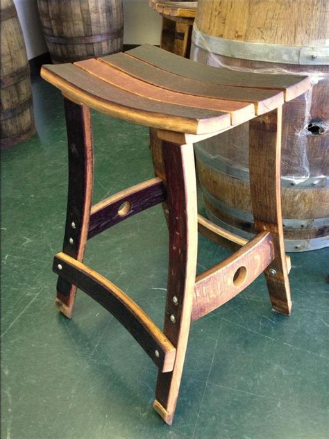 The solid wood legs of this bar height stool mimic the look of a whiskey barrel for a unique seating option for the brewpub feel at home. Whiskey barrel bar stool … | Pinteres…