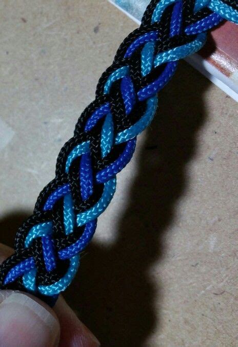 Braid the outer strands towards the center. Black, lt blue, dk blue #95 paracord 4 strand braid ...