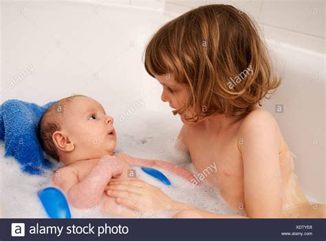 Lift your baby out and pat them dry, paying special attention to the creases in their skin. Little girl and her brother sitting in a bath tub (4 years ...