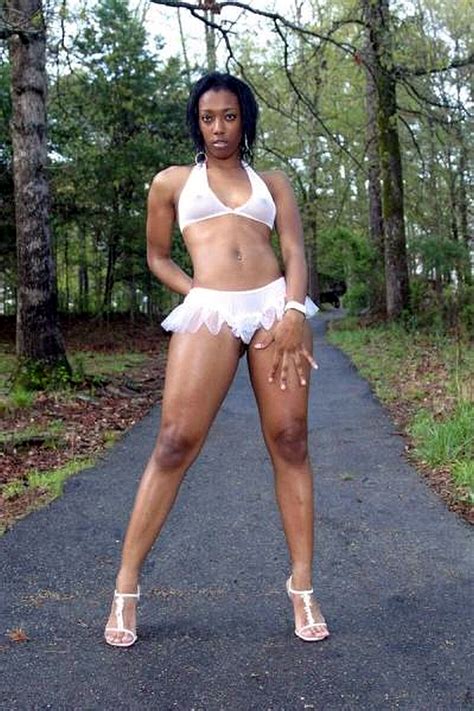 Our moms' r fine with it. Young ebony model posing in white lingerie in the woods ...