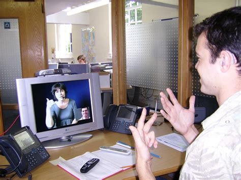 File:Deaf or HoH person at his workplace using a Video Relay Service to ...