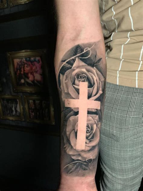 Yuli sandoval is our youngest and one of our most talented black and grey realism artists. A beautiful healed rose with a negative cross design ...