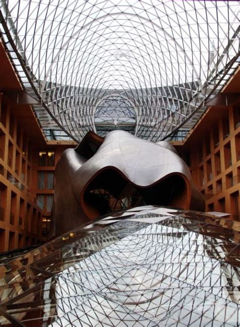 The interior of the oval conference room is paneled with thin strips of red oak. DZ Bank in Berlin | Frank gehry, Gehry architecture, Gehry