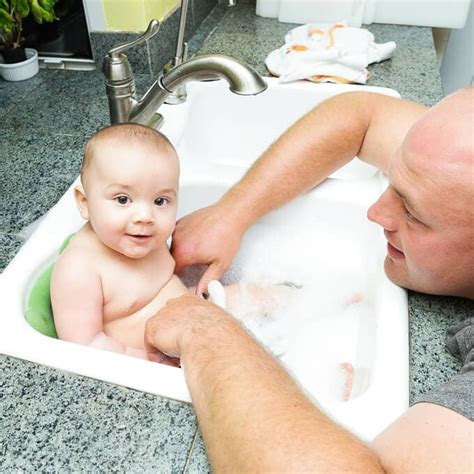 Cute smiling baby taking bath in kitchen sink. Baby Sink Bath Time | Someday I'll Learn