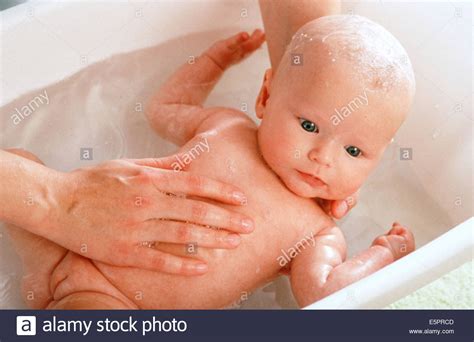 When your baby is ready to go in the tub, it's fine to use just water. 3-month-old baby girl taking a bath Stock Photo, Royalty ...