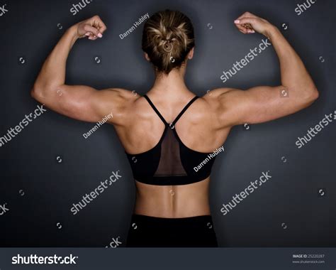 Fitness woman flexing her strong ripped muscles. Female Bodybuilders Muscular Back Flexing Stock Photo ...