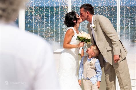 What to get a couple for their wedding. A newlywed couple share their fist kiss as husband and ...