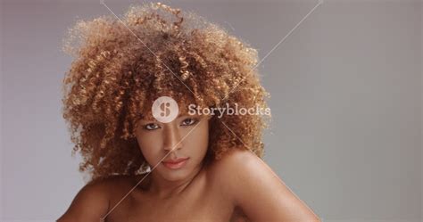 Curly hair needs layers to move. mixed race black woman with neutral makeup portrait. Curly ...