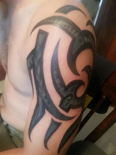 Look at how this marvelous tattoo makes the bicep seem bigger and more macho. tribal coverup arm black and grey bicep tattoo | Bicep ...