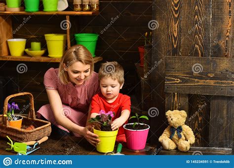 How planting a garden helps the environment. Environment Concept. Little Child Help Mother Planting ...