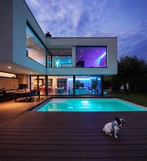 Bedroom in modern villa with pool and deck. Modern Villa With Colored Led Lights At Night Stock Photo ...