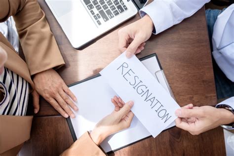 How to address a letter of resignation envelope. Hand of a businessman hands over a resignation letter on a woode - Moore Diversified Services, Inc.