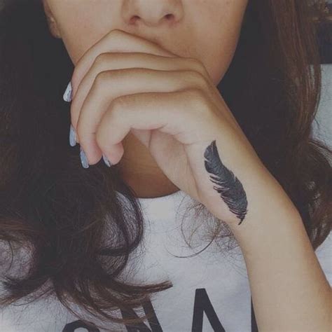 Small feather tattoo on hand. #tattoo #faith #hope #black #small #feather #on #hand # ...