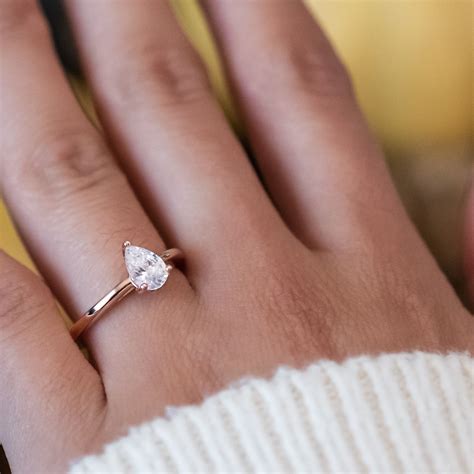 Embrace the warm, rich hues of rose gold engagement rings. Petite Teardrop Solitaire Engagement Ring | Pear engagement ring, Tear drop engagement ring ...