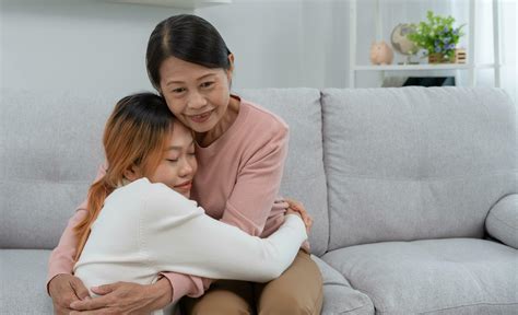 Mother day, cute asian teen girl hugging mature middle age mum. Love