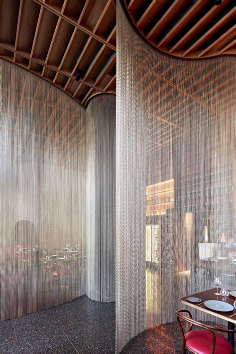 Bronze chainmail curtains add drama to Qualia restaurant ...