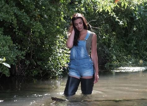 Woman wearing rubber boots with umbrella in autumnal alley. #kayak #fishing #kayak_fishing #canoe #boat #paddle # ...