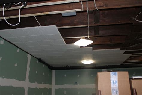 Each broken ceiling tile increases the cost of the project. Construction Progress Page 1