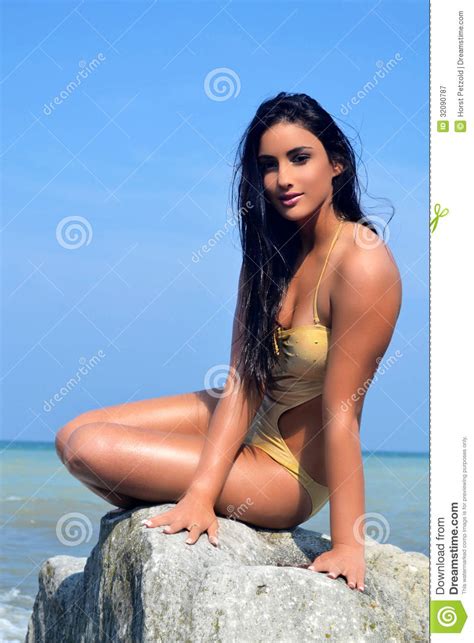 It often happens right around the nipples, but sometimes it might be between the breasts. Girl Sitting On Rock. Royalty Free Stock Photography ...